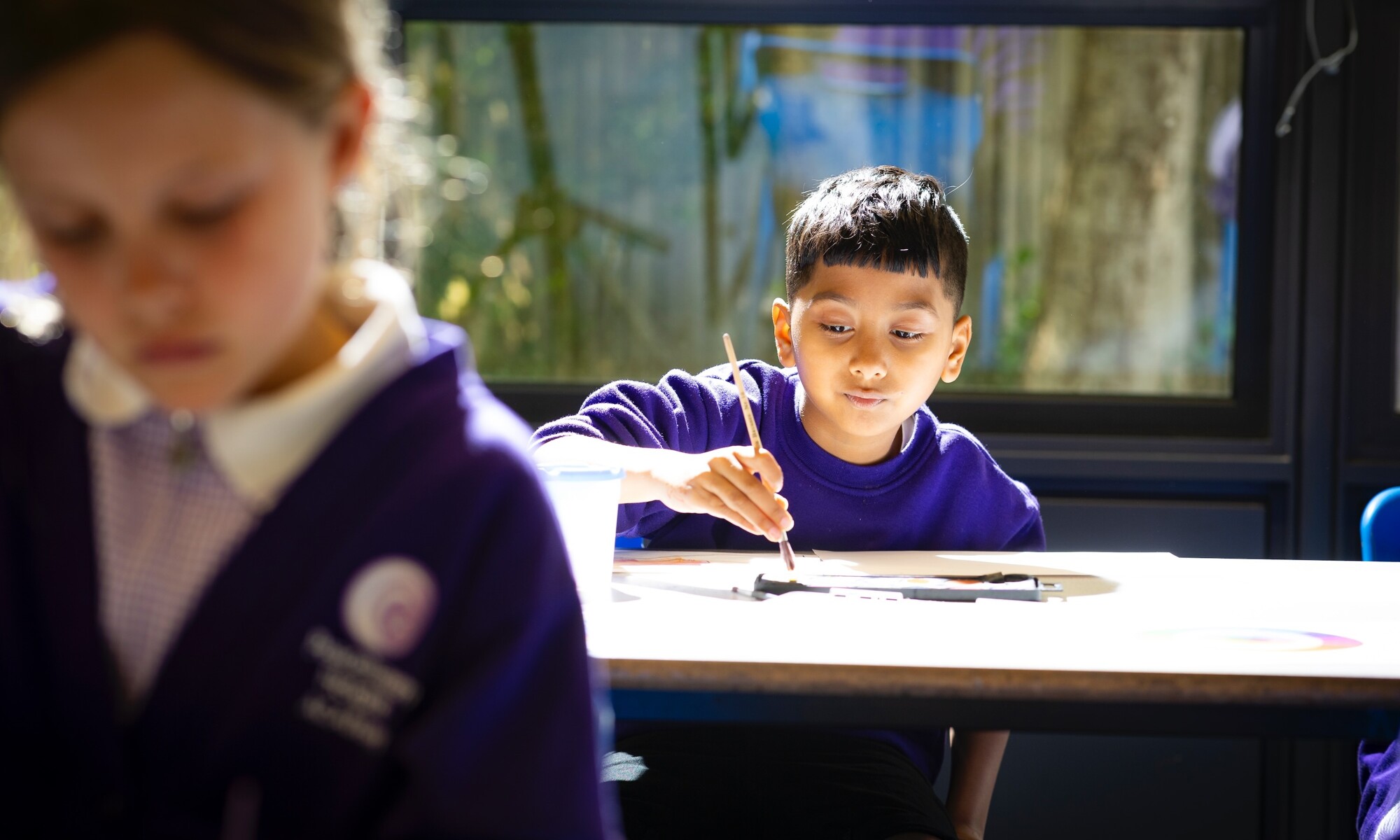 Peacehaven Heights Academy Image of pupil painting during an art lesson